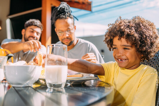 Latinx Gay Couple Having Breakfast With Their Curly-haired Son