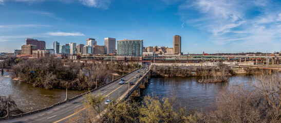 Aerial panorama of Richmond Virginia views of the Mayo and Manchester bridge over the James river, floodwall, industrial railroad tracks, downtown business district, Shockoe slip, capitol district