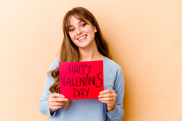 Fototapeta na wymiar Young caucasian woman holding a Happy Valentines day isolated happy, smiling and cheerful.