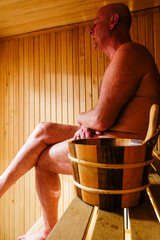 A man sweats in a sauna.