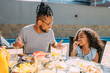 Happy latinx family having breakfast at home