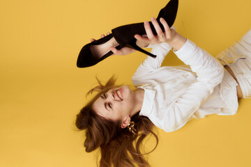 cheerful pretty woman lying on the floor black shoes fashion fun