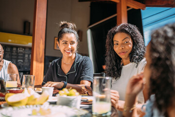 Happy Latinx family having breakfast at home.