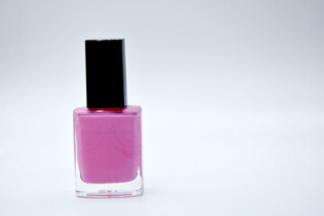 Pink nail polish on white background