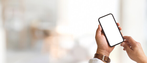 Male hands using smartphone include clipping path in blurred background