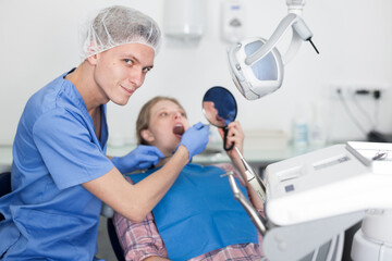 Obraz premium Young woman on dental checkup in modern dentist office. High quality photo