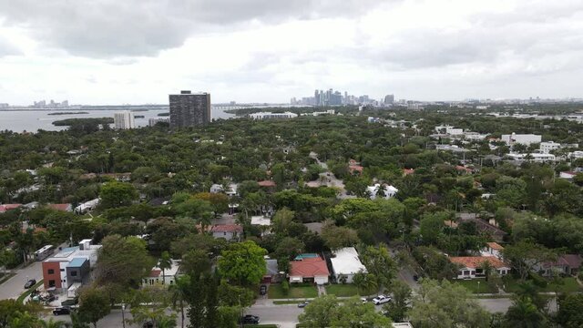 Aerial of suburban Miami with downtown Miami, Florida visible in the distane.  An aerial railcam video clip