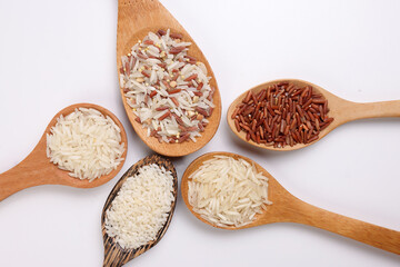 Long grain basmati medium grain jasmine short grain pilaf polau risotto brown low glycaemic index gi rice in wooden spoon on white background copy text space top flat lay view
