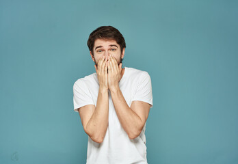 Energetic man gesturing with his hands on a blue background joy emotion delight model