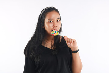 Fashion portrait young woman and lollipop is having fun over white background.