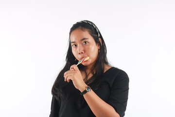 Fashion portrait young woman and lollipop is having fun over white background.