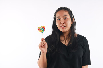 Fashion portrait young woman and lollipop is having fun over white background.