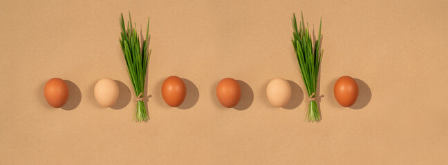 Banner eggs with fresh green grass on a natural paper background.