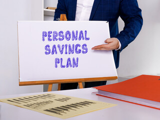 Financial concept about PERSONAL SAVINGS PLAN with phrase on the page.