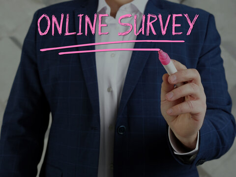 Budget analyst writing ONLINE SURVEY on a transparent virtual interface with a marker pen