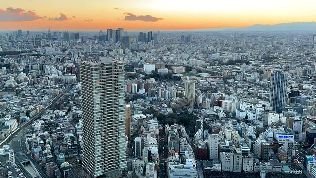 TOKYO, JAPAN : Aerial sunrise CITYSCAPE of TOKYO. View of dawn sky and buildings around Ikebukuro and Shinjuku city. Japanese city life and urban metropolis concept. Time lapse video, night to morning