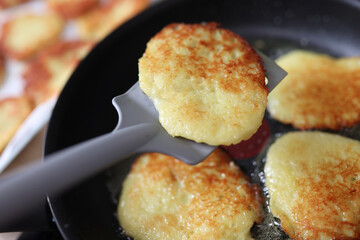 Fried potato pancakes in pan. Cooking at home