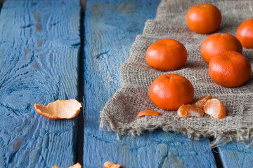 Empty space for text. Mandarins on a background of a blue boards.