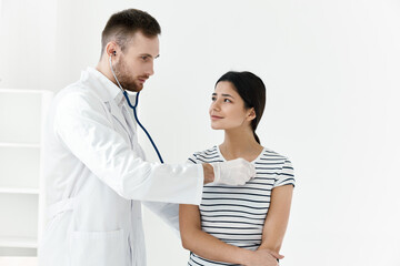 doctor in a white coat stethoscope examination of a patient hospital