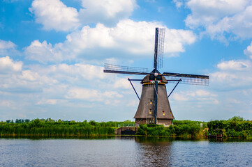 Typical Dutch windmill at the UNESCO world heritage site Kinderdijk village in the Netherlands - 422222786