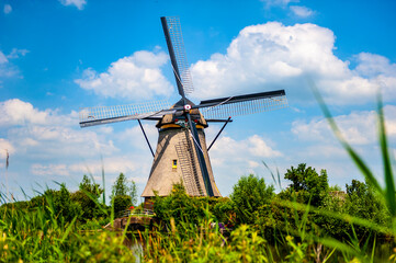 Beautiful rural view in the south of the Netherlands with an old traditional Dutch windmill at Kinderdijk - 422222917