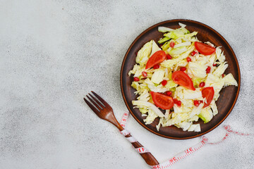 Concept of proper nutrition and diet, healthy food, vegetable salad of peking cabbage, pomegranate seeds and cherry tomato, vegan eating and detox nutrition