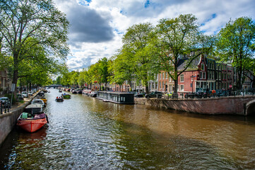 Amsterdam, Netherlands - July 7, 2019: Amsterdam canals and traditional Dutch houseboats on a summer day in the Netherlands - 422224922