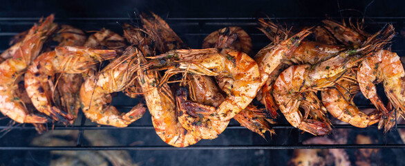 Shrimp, prawns grilled on barbecue fire stove - 422224992