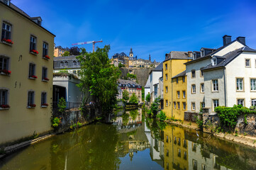 Fototapeta na wymiar Luxembourg city, Luxembourg - July 16, 2019: Cozy old riverside houses in the old town of Luxembourg city in Luxembourg
