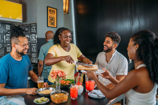 Happy Latinx Family Having Barbecue Party In Home