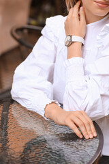 Obraz na płótnie Canvas Woman with stylish wrist watch sitting in cafe