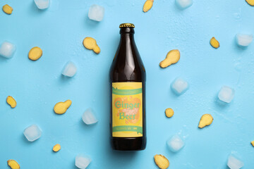 Bottle of fresh ginger beer on color background