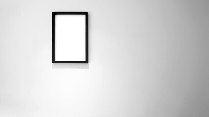 Monochrome/black and white. Empty black frame at the light color wall
