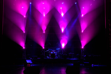 The light of searchlights in smoke on stage.