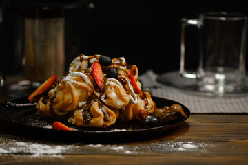 profiteroles. Sweet cake with strawberries. Custard cakes.
