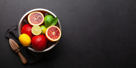 Various fresh citrus fruits in colander. Bood orange, lime, lemon