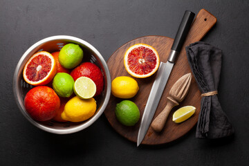 Various fresh citrus fruits in colander. Bood orange, lime, lemon