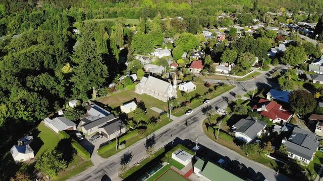 St Patricks Catholic Church, Arrowtown, New Zealand. Aerial orbit, sunny evening