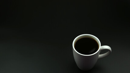 Close up black hot coffee white mug with black background.