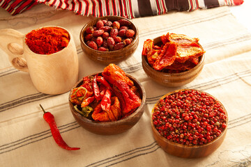 Red colored food. Dried healthy food spices. Dried tomatoes, dried peppers, rosehips, red pepper seeds, red pepper.
