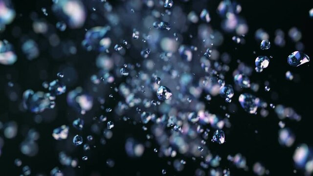 Dark liquid drops flying in super slow motion 4K