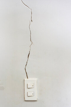 White Wall With Severe Cracked Groove Near The Light Switch 