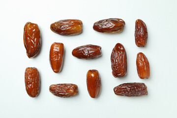 Flat lay with tasty dates on white background
