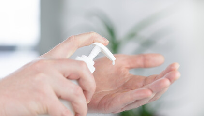 A man's hands apply the cream on his hands. The concept of skin care.