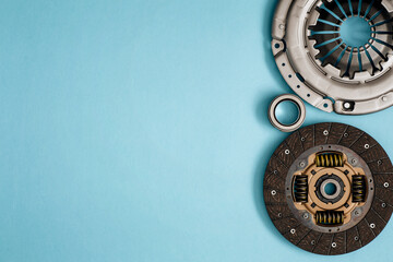 Automotive clutch mechanism, disc, basket and bearing for auto on a blue background.