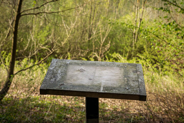 Fototapeta premium Empty signboard in the Vogelsangbachtal near Heiligenhaus, North Rhine-Westphalia, Germany