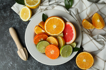 Concept of ripe food with different citrus on black smoky table