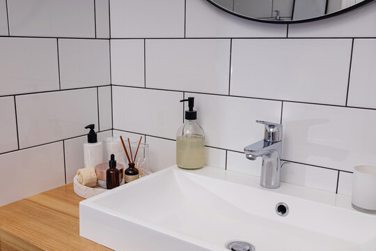 Body and face care essentials in the white bathroom.