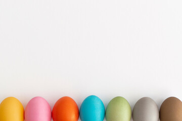 Colored eggs on a white background. Minimal easter concept.