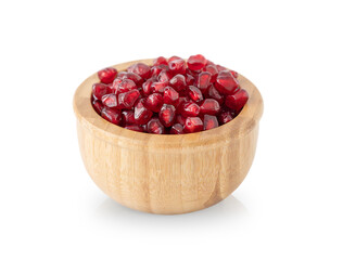 Red pomegranate seeds in wooden bowl isolated on white background